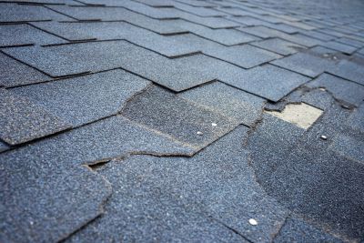 Worn out damaged roof shingles